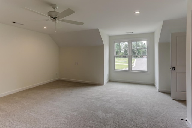 additional living space with light carpet, lofted ceiling, and ceiling fan