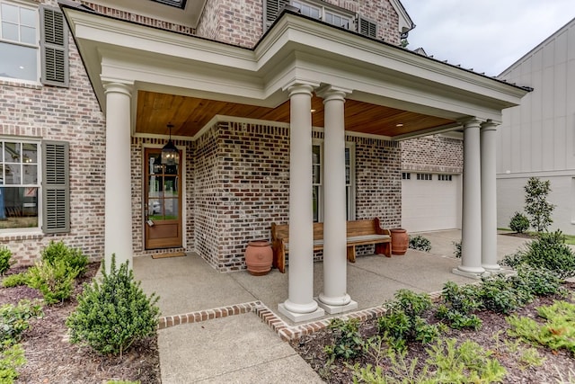 entrance to property featuring a porch and a garage