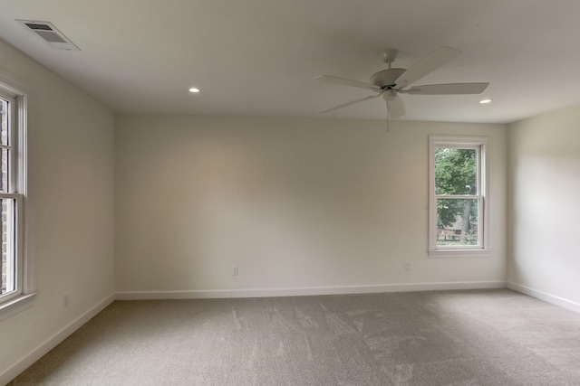 carpeted empty room featuring ceiling fan