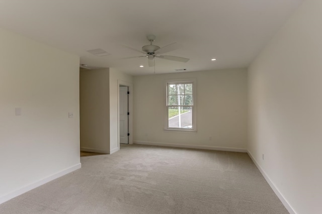 empty room with ceiling fan and light colored carpet