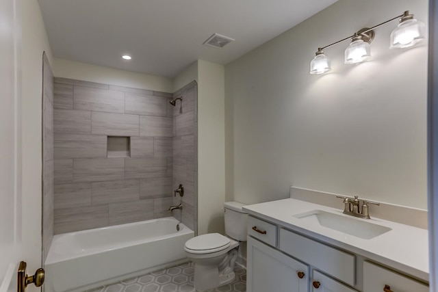 full bathroom featuring toilet, vanity, tiled shower / bath, and tile flooring