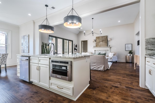 kitchen featuring pendant lighting, stainless steel oven, dark wood-type flooring, an island with sink, and white cabinetry