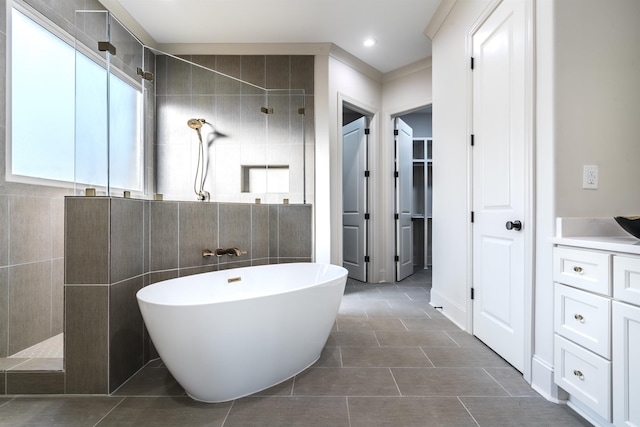 bathroom featuring separate shower and tub, tile patterned flooring, and tile walls