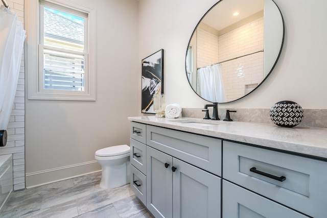 bathroom featuring vanity, toilet, and curtained shower