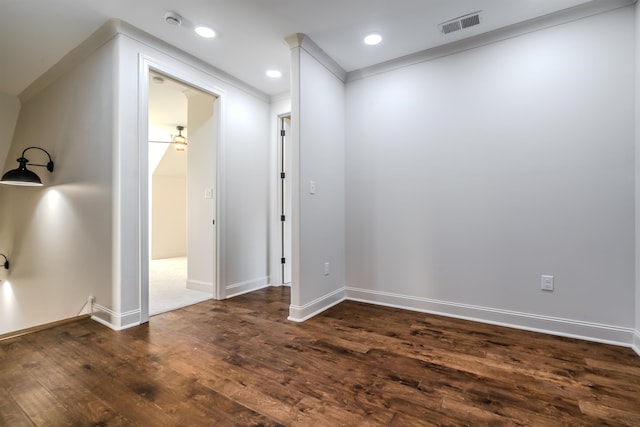 unfurnished room featuring dark hardwood / wood-style flooring, ceiling fan, and ornamental molding