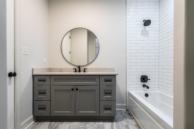 bathroom with vanity and tiled shower / bath