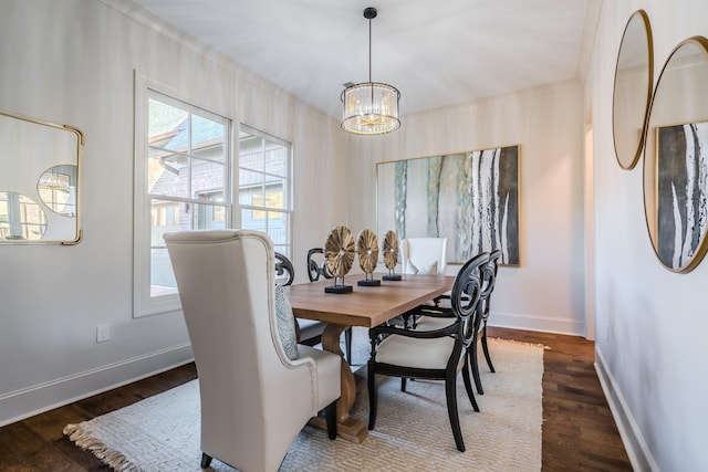 dining space featuring dark hardwood / wood-style floors and an inviting chandelier