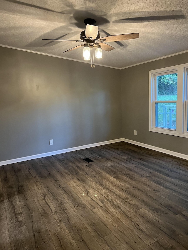 empty room featuring a textured ceiling, dark hardwood / wood-style flooring, and crown molding