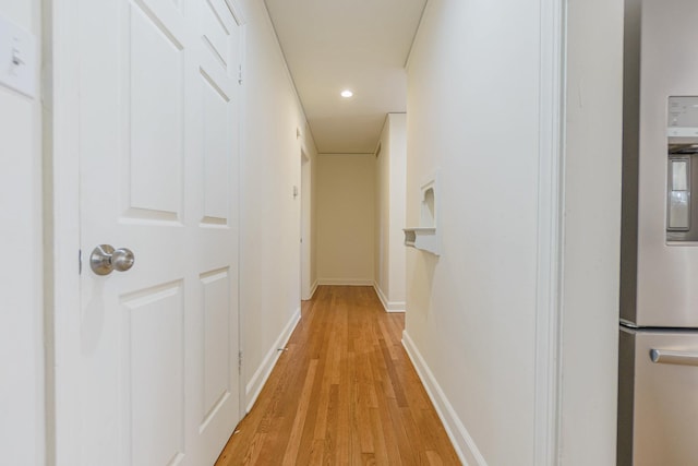 hallway featuring recessed lighting, light wood-style flooring, and baseboards