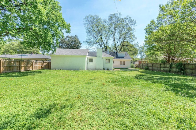 view of yard with a fenced backyard