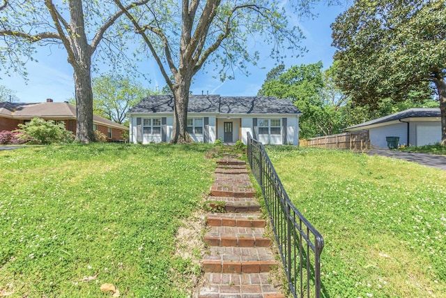 single story home featuring a front yard and fence