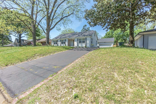 ranch-style home featuring a front yard and fence