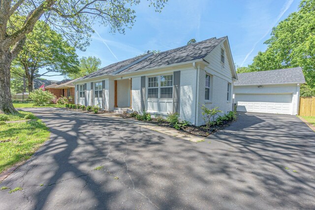 view of front of home with a garage and brick siding