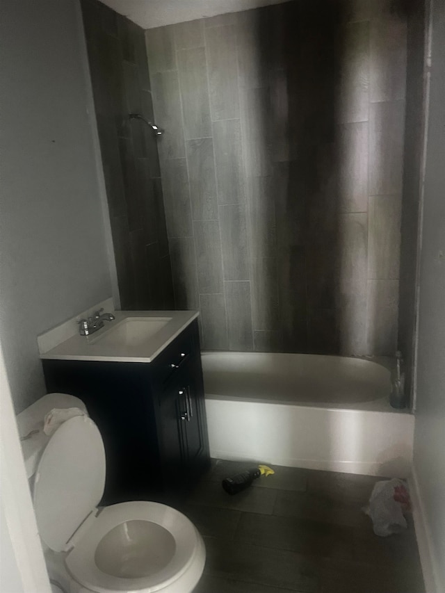 full bathroom featuring tile patterned flooring, vanity, toilet, and tiled shower / bath