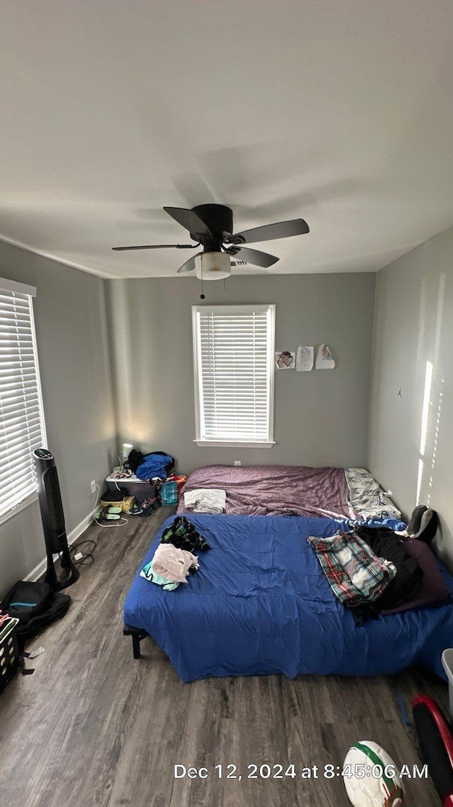 bedroom with wood-type flooring and ceiling fan