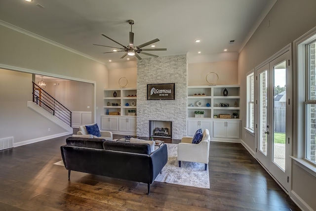 living room with dark hardwood / wood-style flooring, a fireplace, and a healthy amount of sunlight