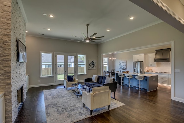 living room with ornamental molding, dark hardwood / wood-style floors, and a fireplace