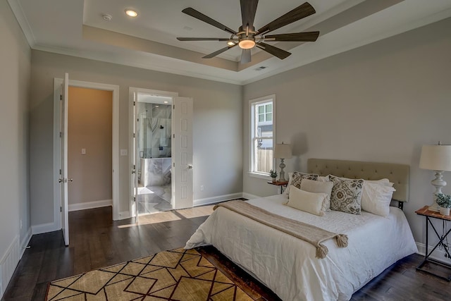 bedroom featuring dark wood-type flooring, ceiling fan, a tray ceiling, and crown molding