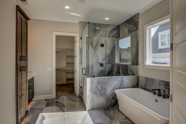 bathroom with ornamental molding, vanity, and independent shower and bath