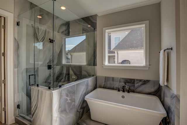 bathroom featuring separate shower and tub