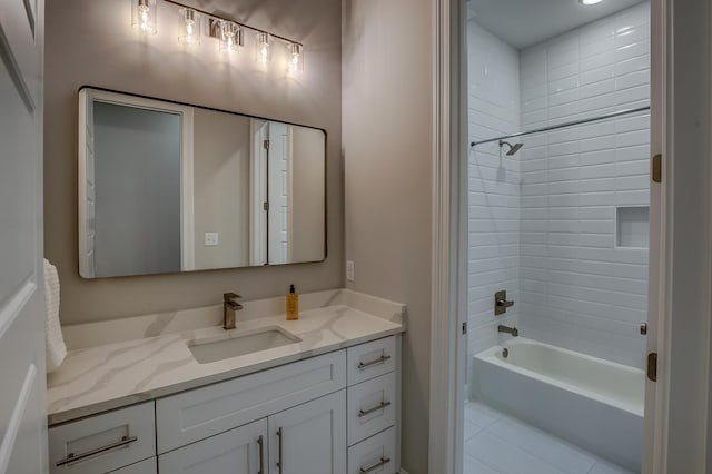 bathroom with tiled shower / bath and vanity