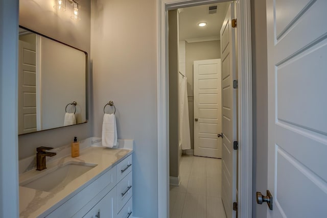 bathroom featuring vanity, tile patterned floors, and ornamental molding