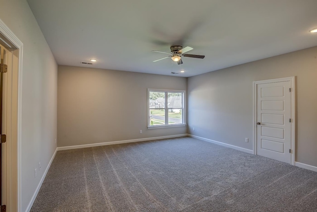 empty room with ceiling fan and carpet flooring