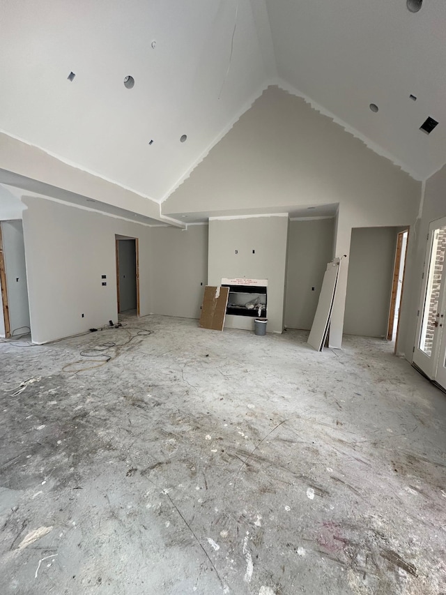 unfurnished living room featuring vaulted ceiling