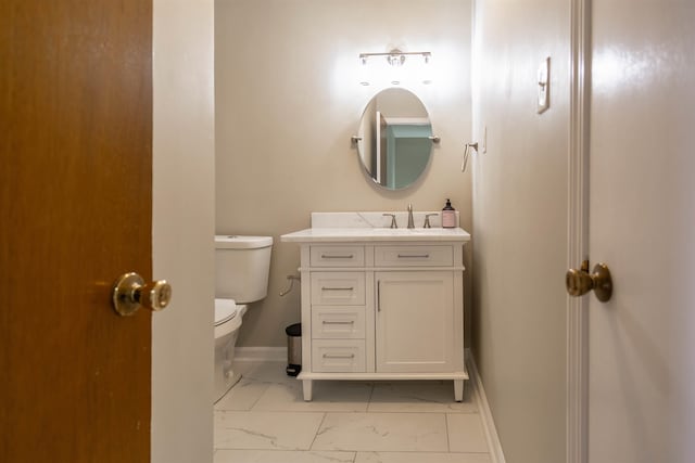 bathroom with toilet, vanity with extensive cabinet space, and tile flooring