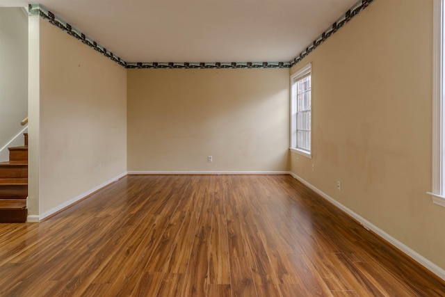 spare room with dark hardwood / wood-style flooring