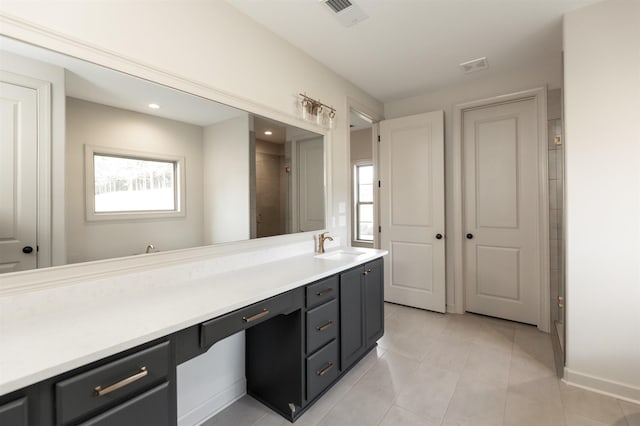 bathroom featuring tile patterned flooring, vanity, and plenty of natural light