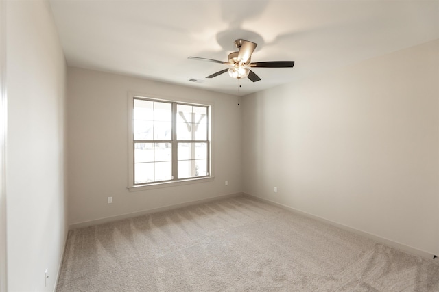 spare room with light carpet and ceiling fan