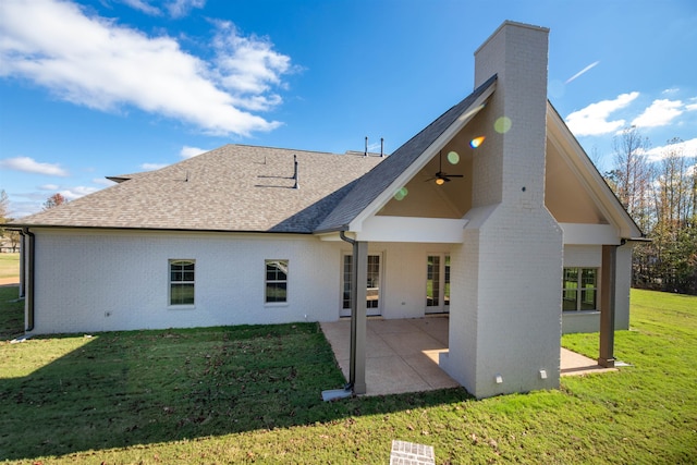 back of house featuring ceiling fan, a patio, and a lawn