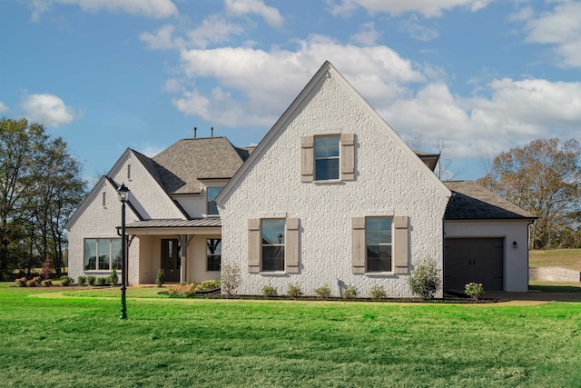 view of front of property with a garage and a front lawn