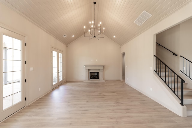 unfurnished living room featuring wood ceiling, a notable chandelier, ornamental molding, light hardwood / wood-style floors, and french doors