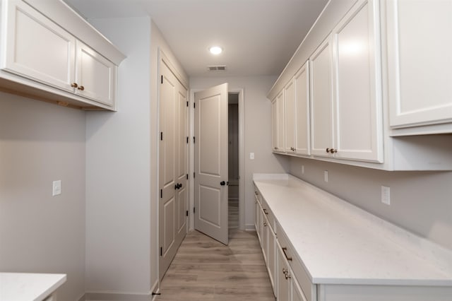 kitchen with white cabinets and light wood-type flooring