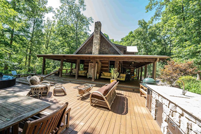 wooden terrace featuring a grill