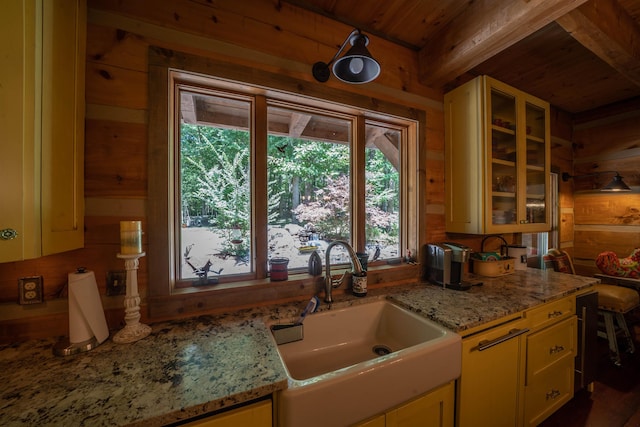 kitchen with wooden ceiling, sink, light stone countertops, and plenty of natural light