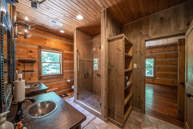 bathroom featuring tile floors, wooden walls, vanity with extensive cabinet space, and wooden ceiling