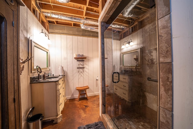 bathroom featuring vanity, a shower with shower door, and concrete flooring