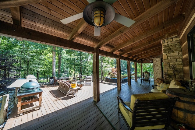 wooden terrace featuring grilling area and ceiling fan