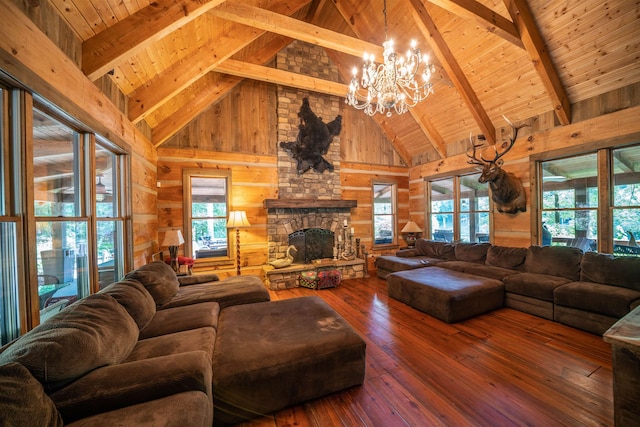 living room with high vaulted ceiling, an inviting chandelier, and dark hardwood / wood-style flooring