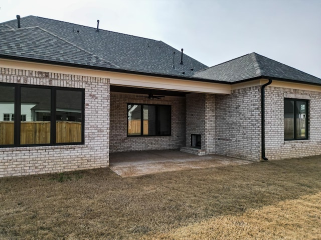 rear view of house featuring a patio area, ceiling fan, and a yard