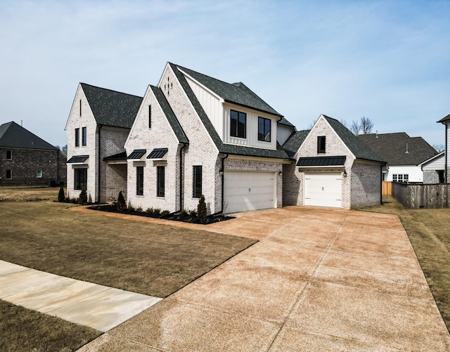 view of front of home with a front yard and a garage