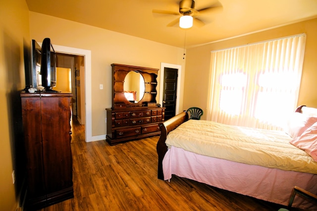 bedroom featuring ceiling fan and dark wood-type flooring