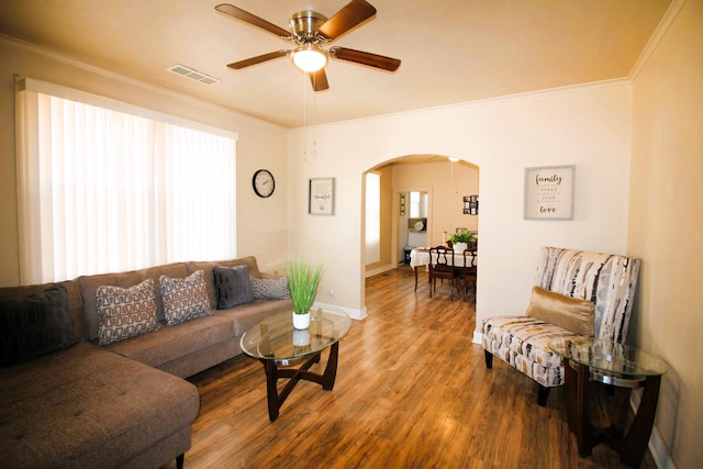 living room with hardwood / wood-style floors, ceiling fan, and ornamental molding