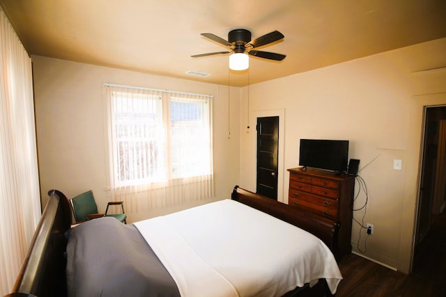 bedroom with ceiling fan and dark hardwood / wood-style flooring