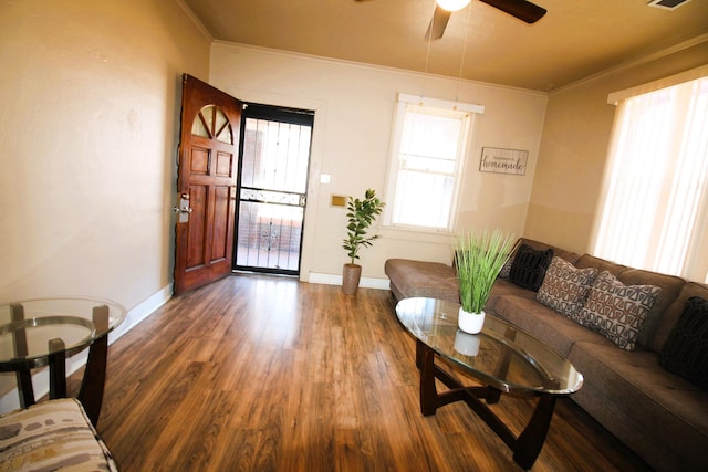 living room with ceiling fan, ornamental molding, and dark hardwood / wood-style floors