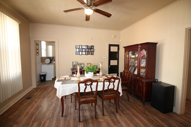 dining space featuring ceiling fan, dark wood-type flooring, and ornamental molding