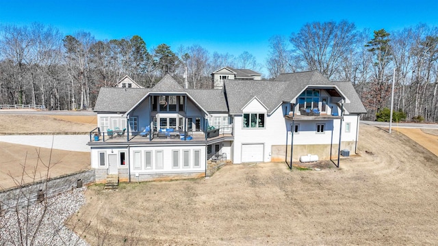 rear view of property with a lawn and a garage